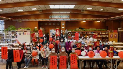 柏林佛光人各執象徵春節的平安燈、春聯、銀柳、鞭炮等，向大眾拜年