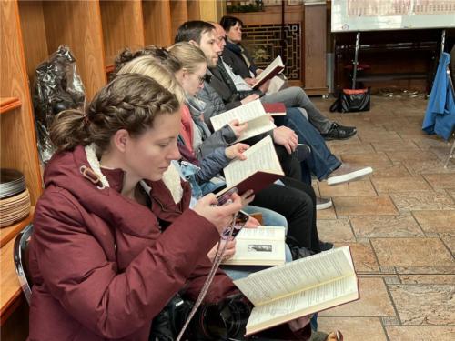 來訪的德國宗教記者拍攝、翻閱道場所翻譯的「德文課誦本」